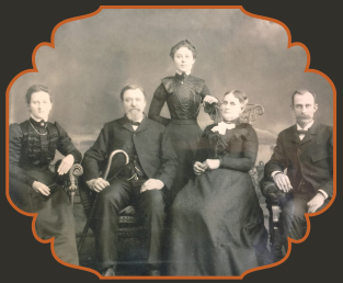 black and white photo of a family in Victorian Dress