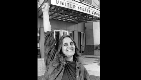 Judi Bari in front of a theater marquee