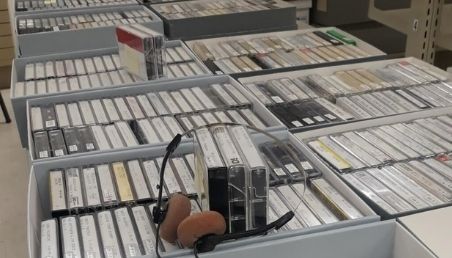 Boxes of cassette tapes and with a pair of headphones