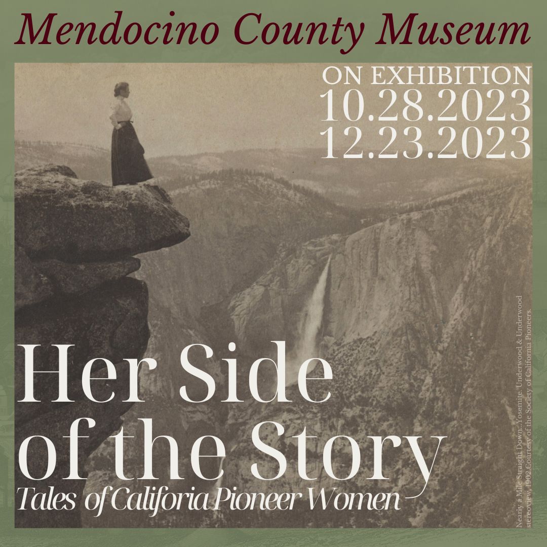 Black and white photo of a woman standing on a high cliff overlooking Yosemite, a waterfall can be seen in the distance. 