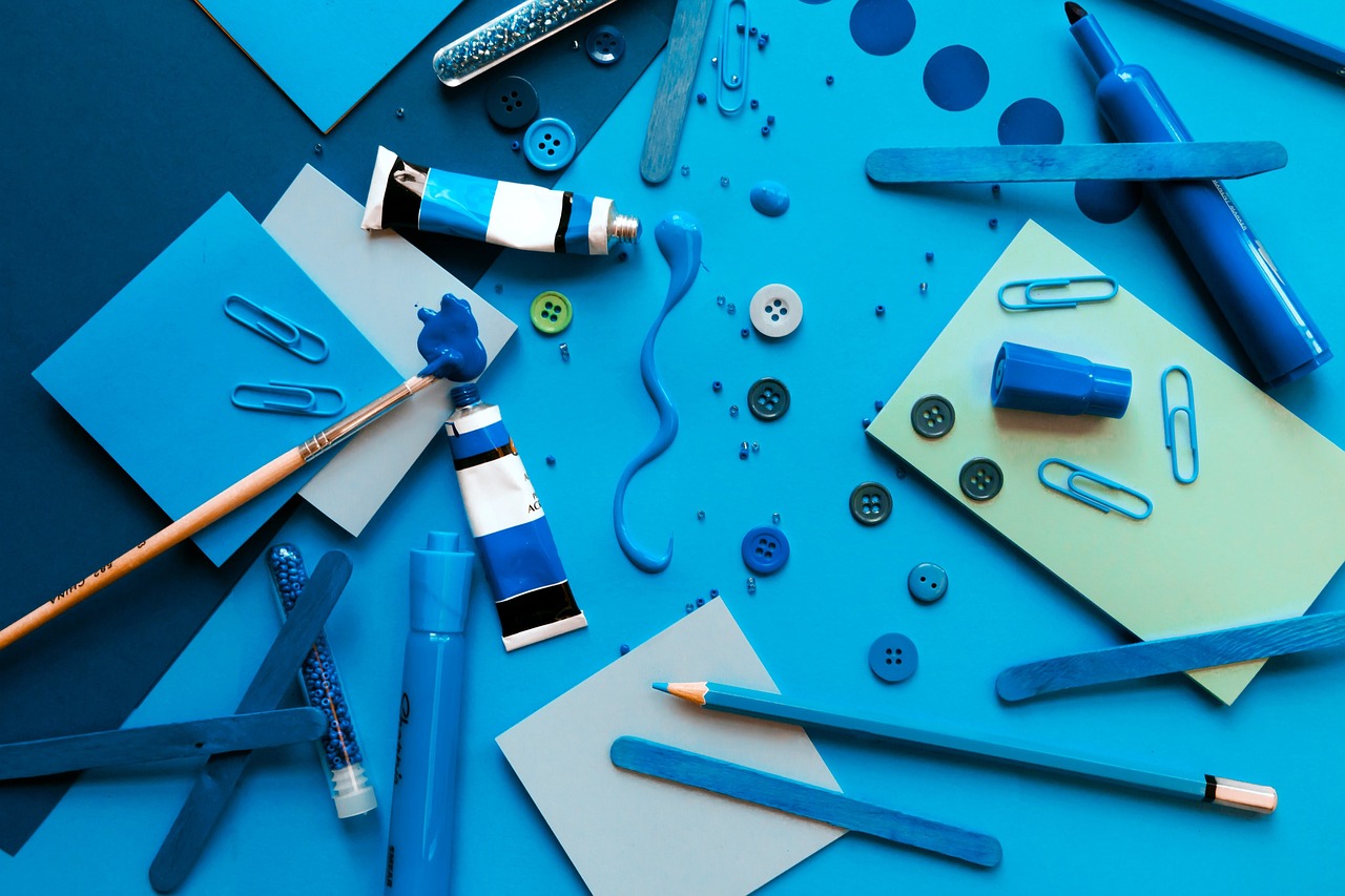 assorted craft supplies scattered on table.