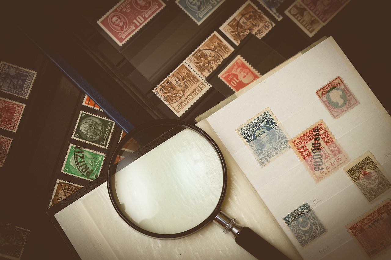 book of stamp collection with magnifying glass.