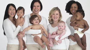 a photo of smiling women holding their babies